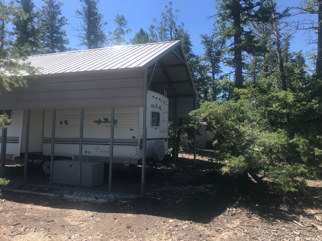 View of property exterior with stacked washing maching and dryer