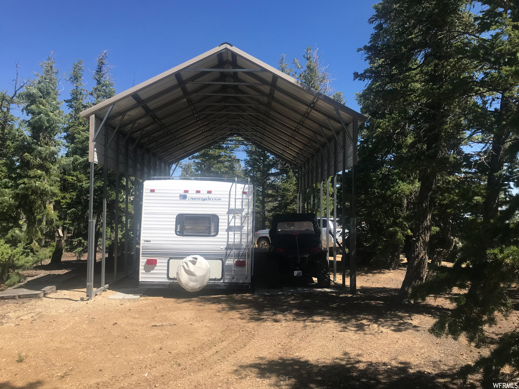 View of parking featuring carport