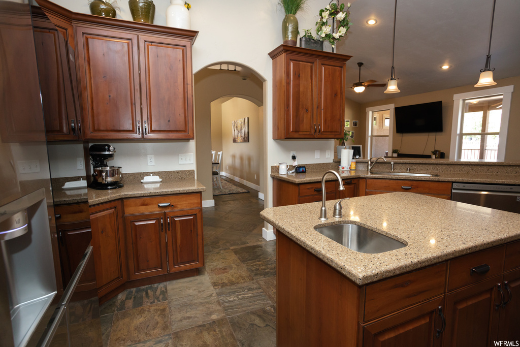 Kitchen featuring dark tile floors and stone counters