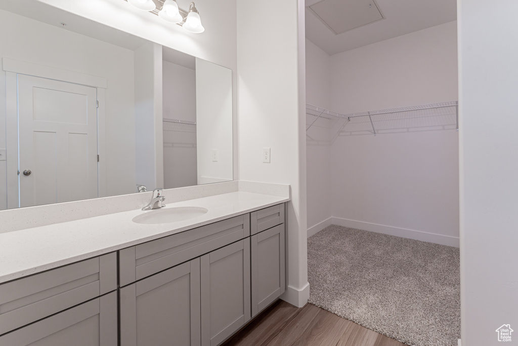 Bathroom featuring oversized vanity and hardwood / wood-style floors