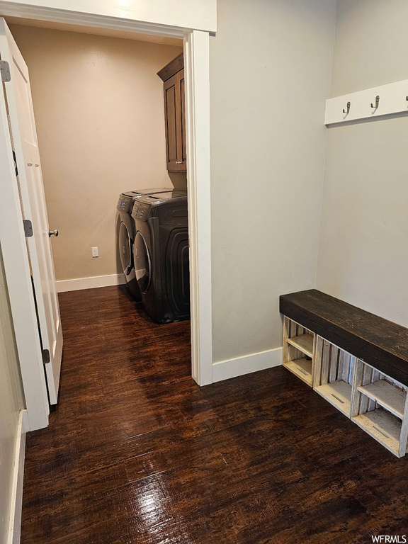 Interior space with dark hardwood flooring and washing machine and dryer