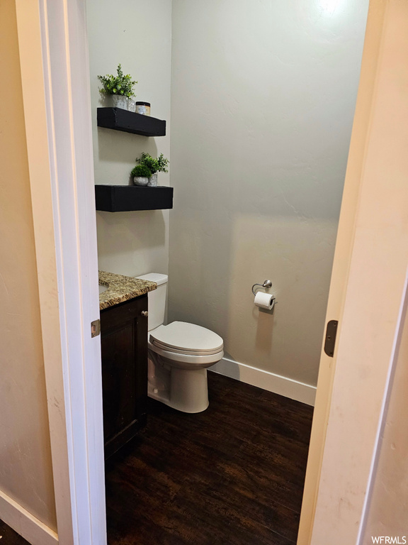 Bathroom featuring vanity and dark hardwood floors