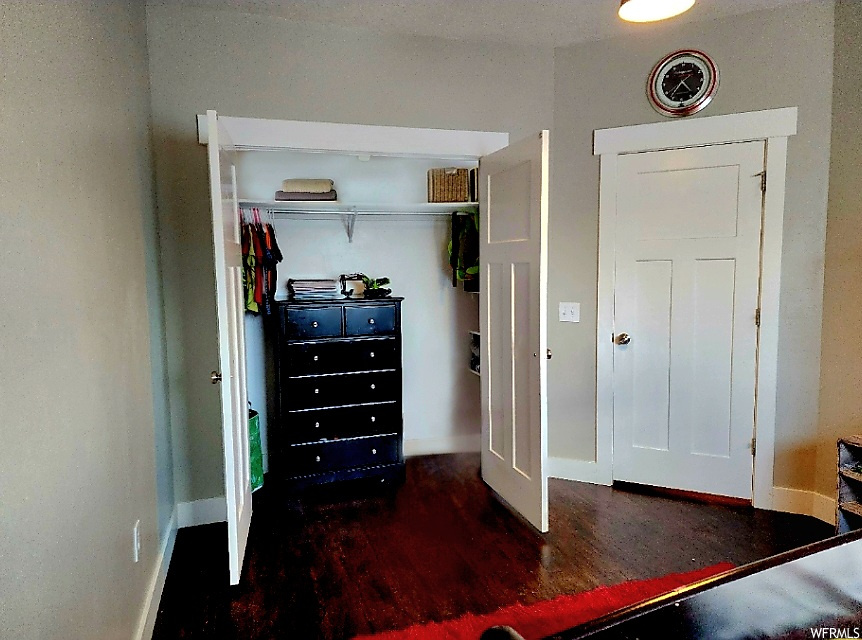 Bedroom featuring dark hardwood floors