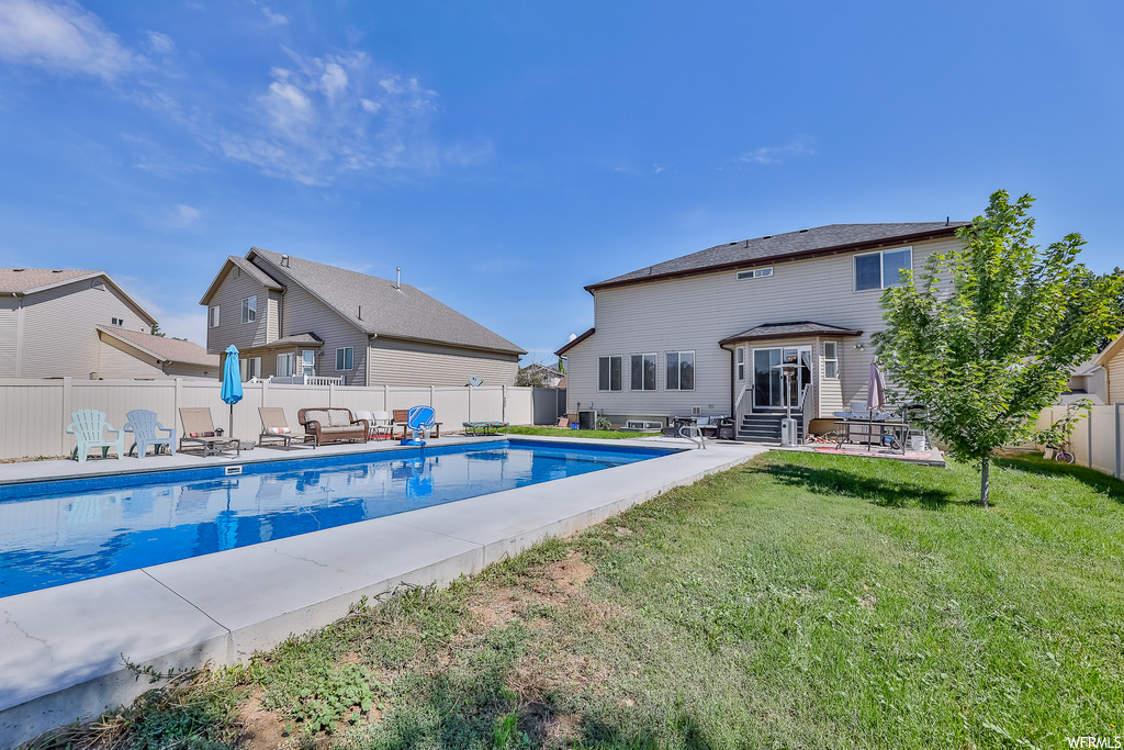 View of pool featuring a lawn