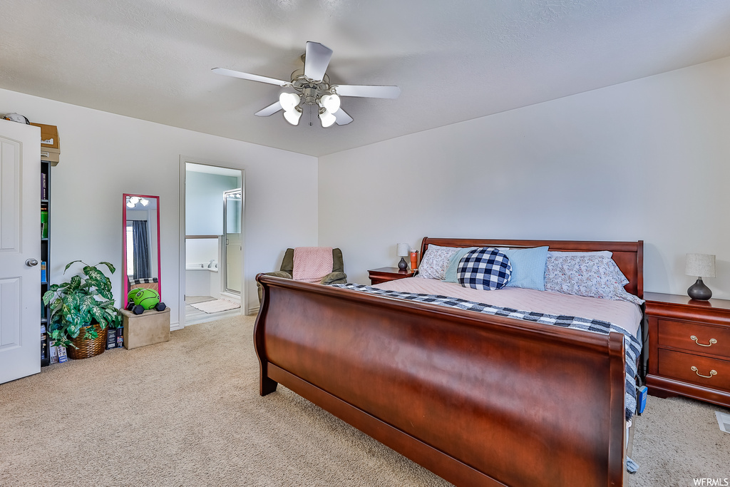 Carpeted bedroom with ceiling fan
