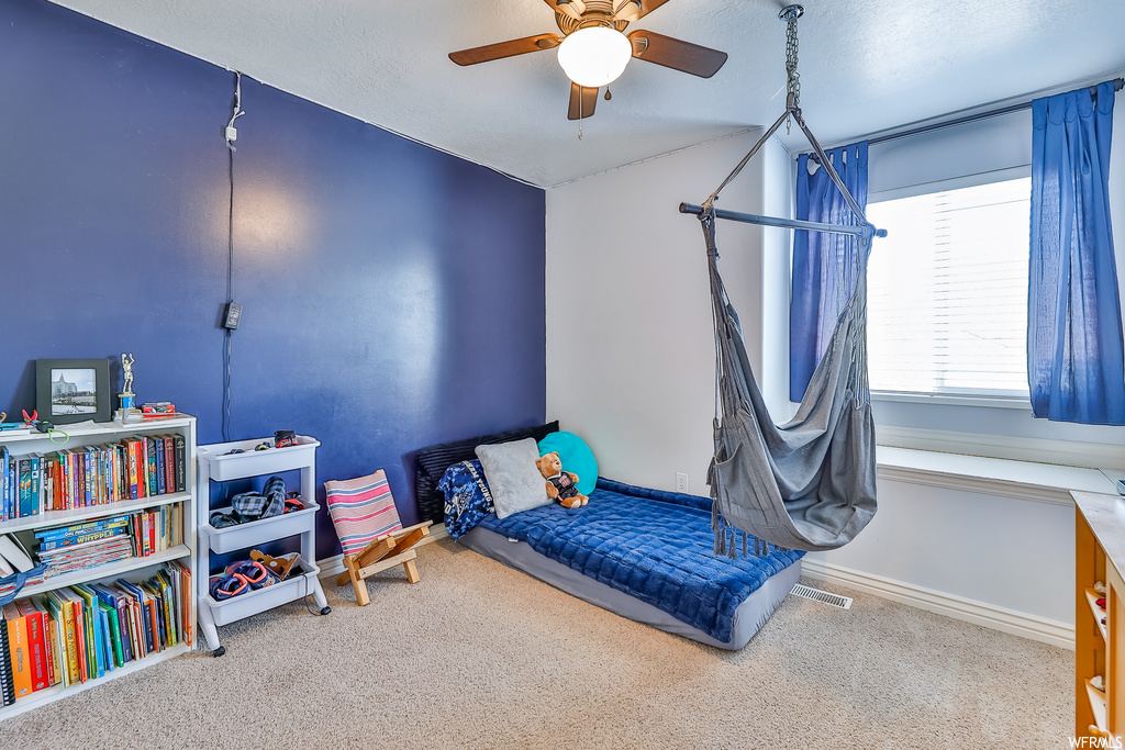 Bedroom with light carpet and ceiling fan