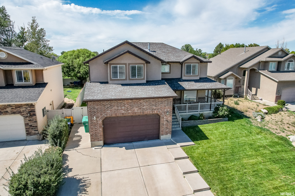 View of front of home with garage and a front lawn