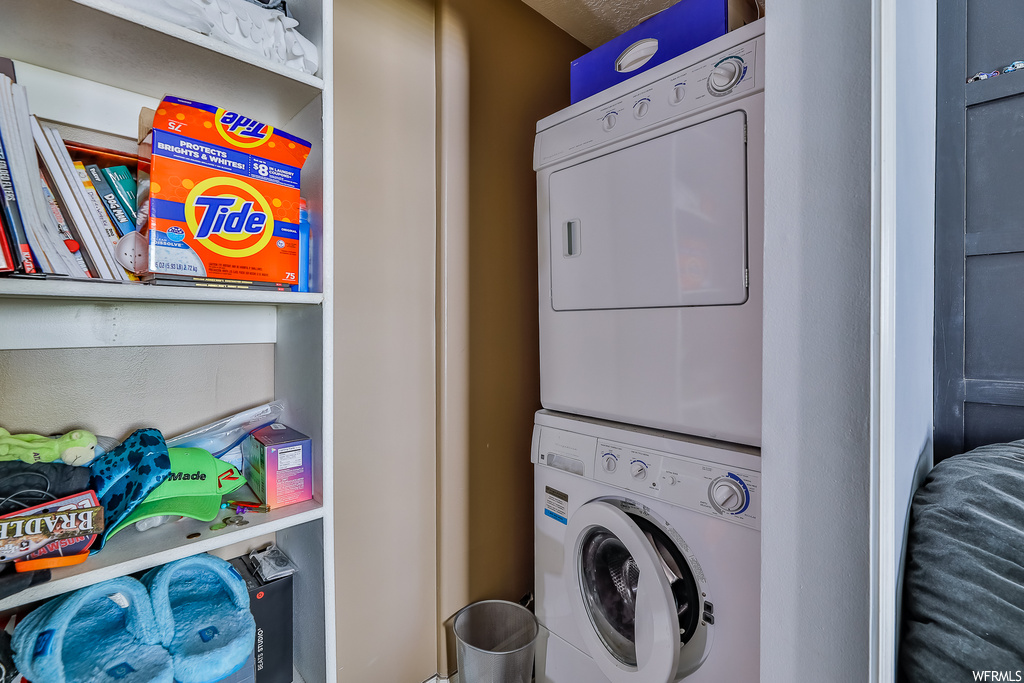 Laundry room featuring stacked washer and clothes dryer