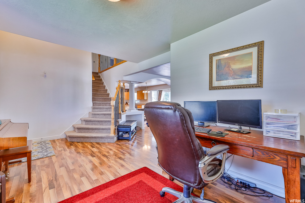 Home office with light hardwood floors