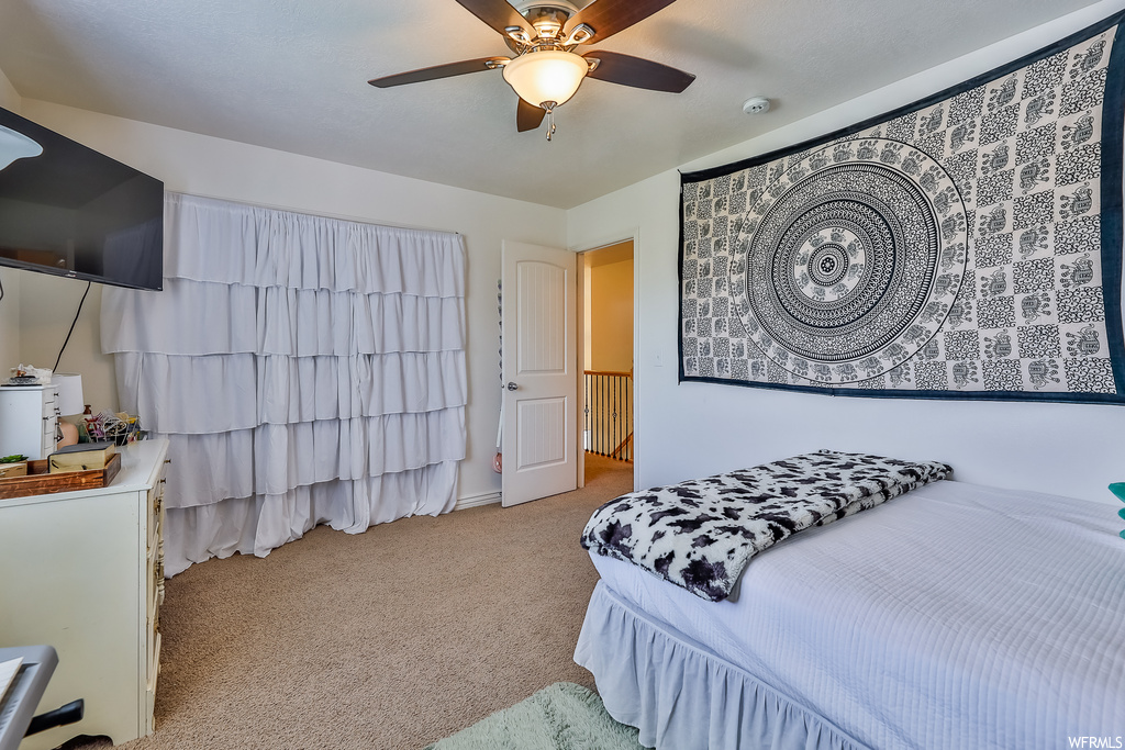Bedroom with light carpet and ceiling fan