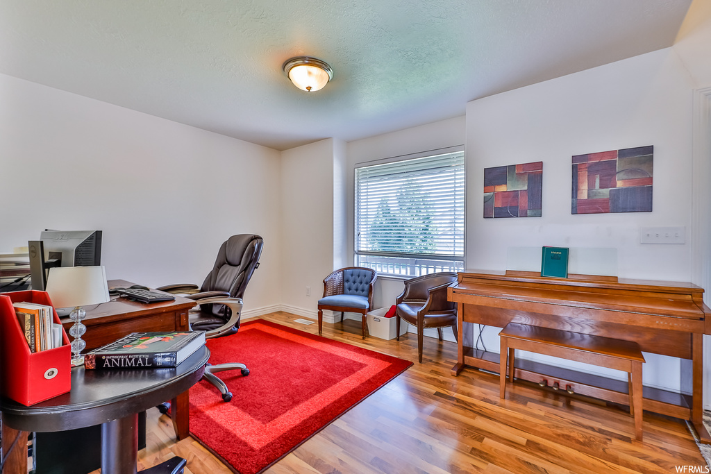 Office with light hardwood floors