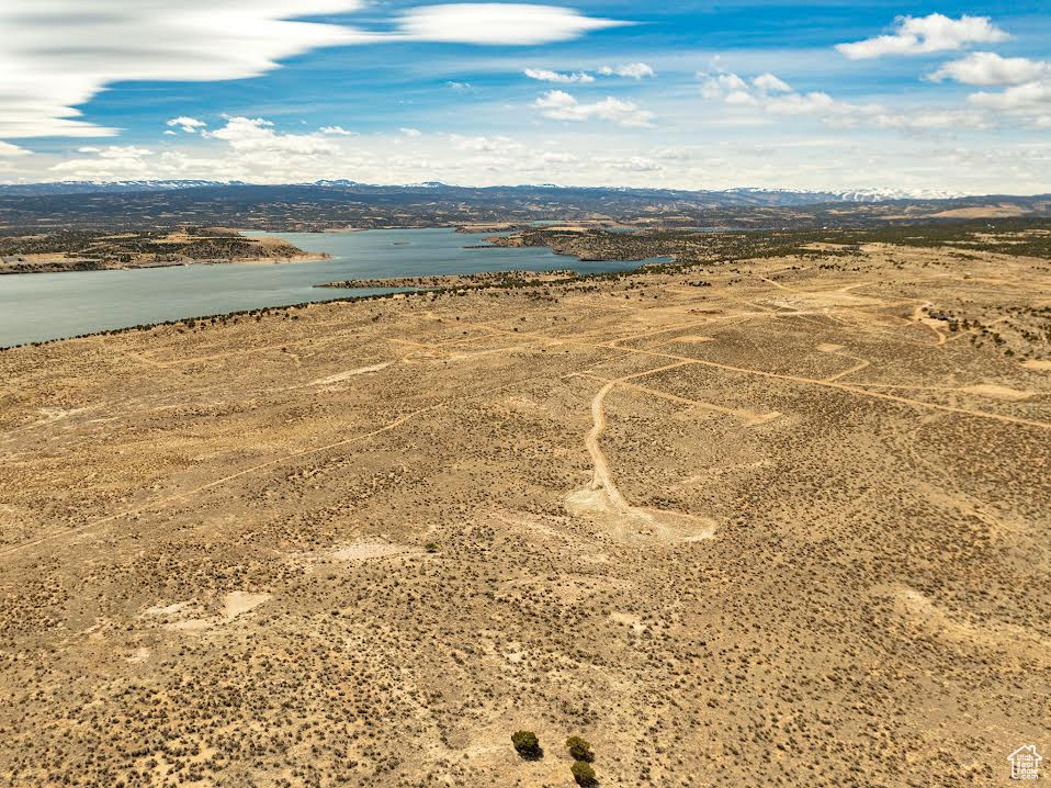 Birds eye view of property with a water view