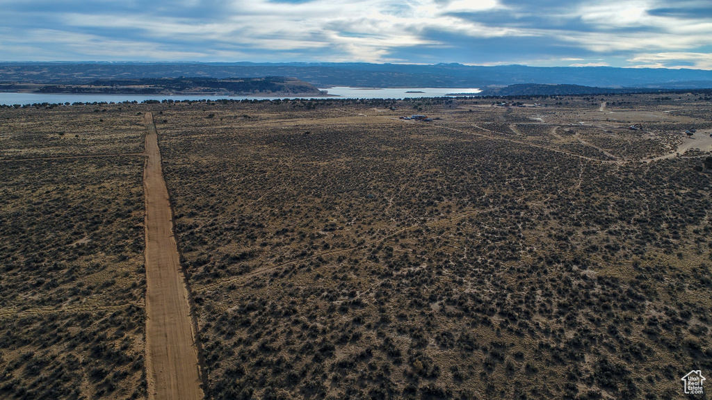 Birds eye view of property with a water and mountain view