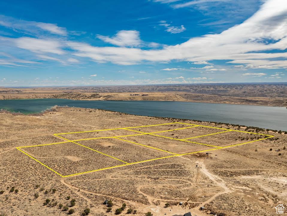 Birds eye view of property with a water view