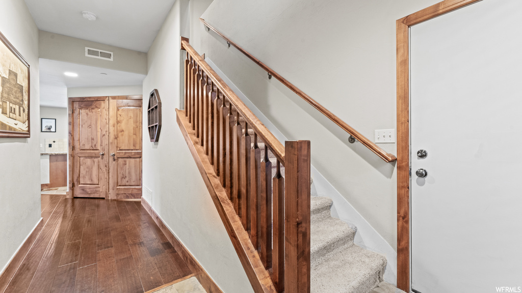 Staircase with dark hardwood flooring