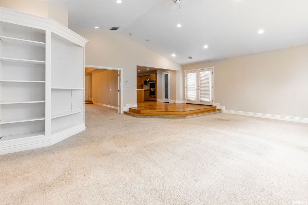 Living room featuring light carpet and lofted ceiling