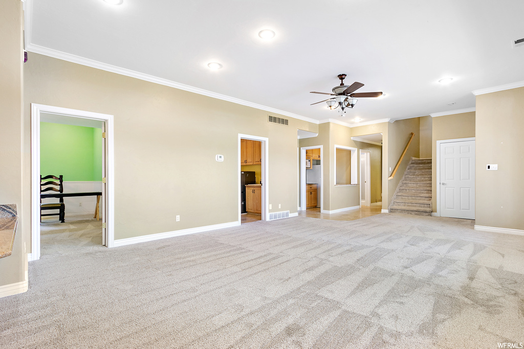 Carpeted empty room with ornamental molding and ceiling fan