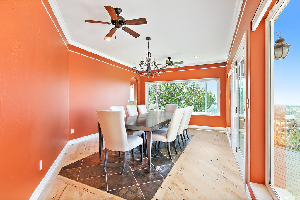 Wood floored dining room featuring crown molding and ceiling fan