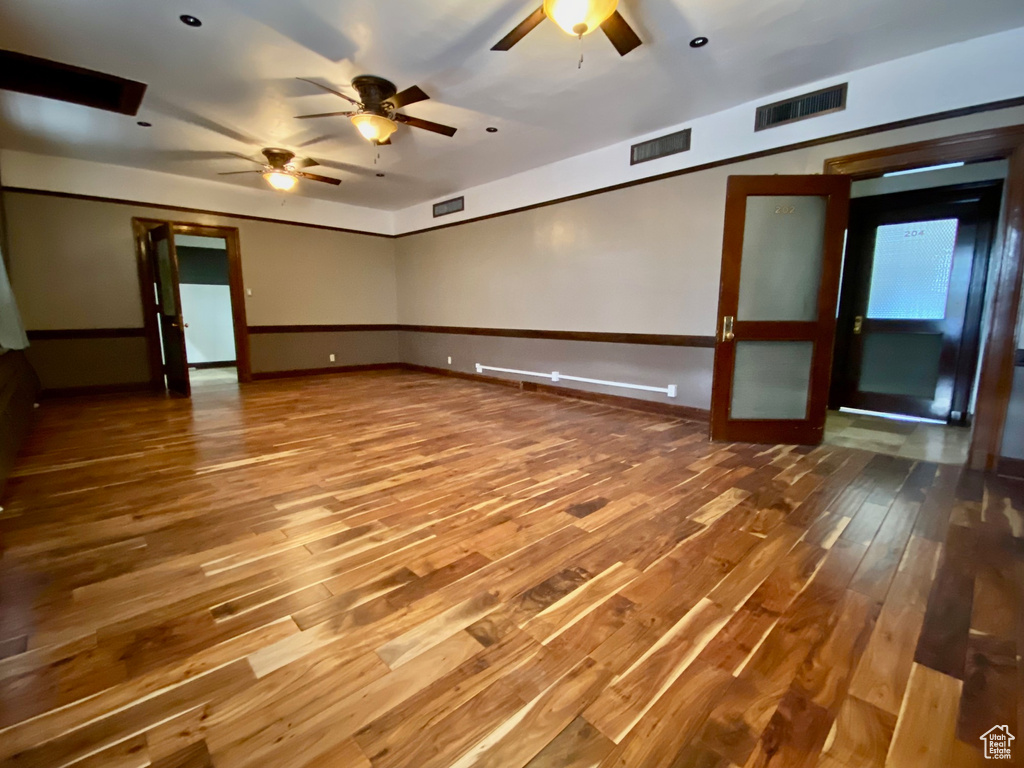 Unfurnished room with ceiling fan and wood-type flooring