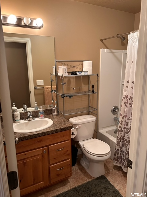 Full bathroom with shower / tub combo, oversized vanity, tile floors, and mirror