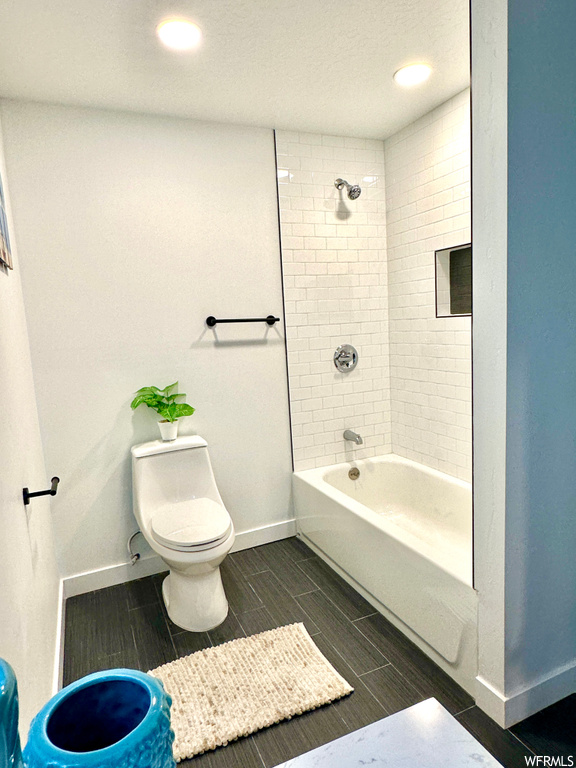 Bathroom with tile floors and tiled shower / bath combo
