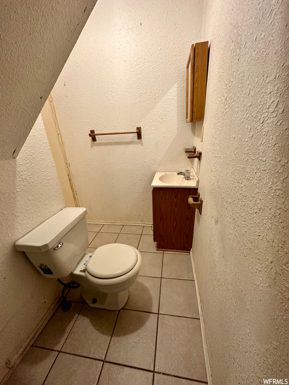 Bathroom featuring vanity and light tile floors
