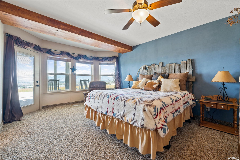 Bedroom featuring light carpet, beam ceiling, and ceiling fan
