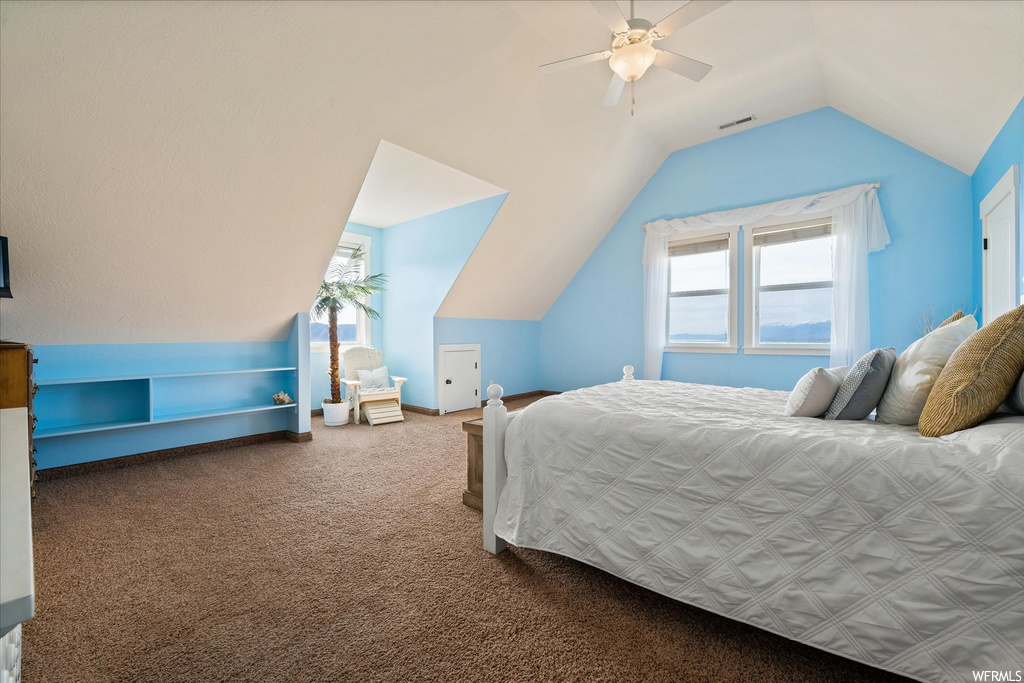 Carpeted bedroom featuring lofted ceiling