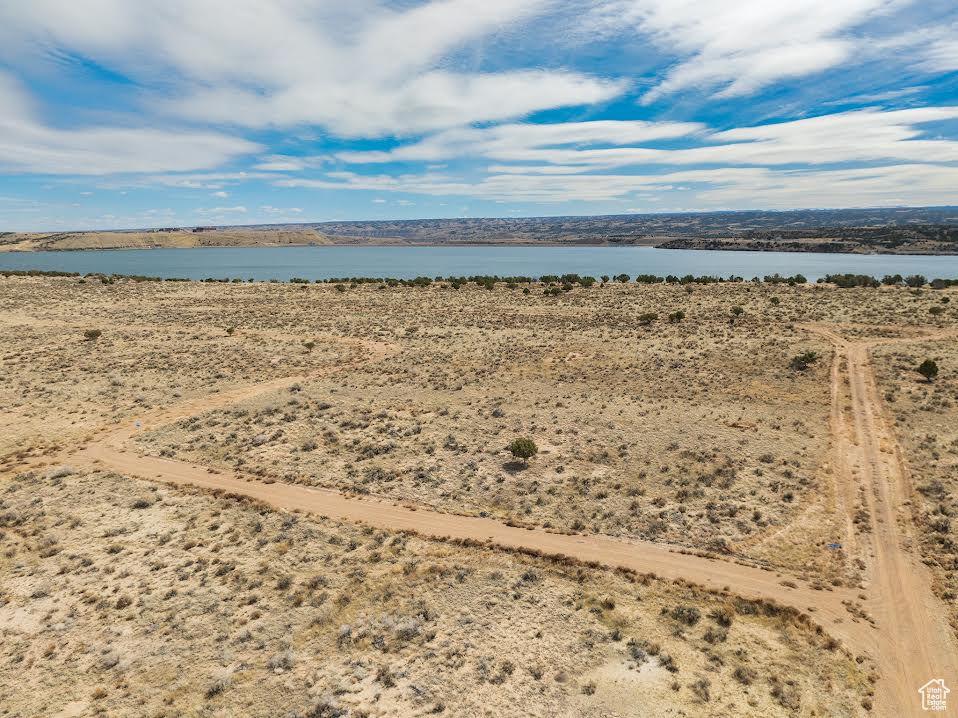 Birds eye view of property with a water view