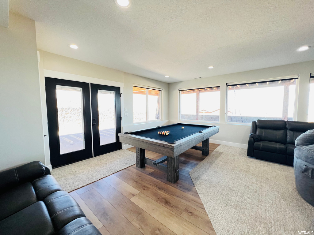 Game room featuring light hardwood floors and french doors