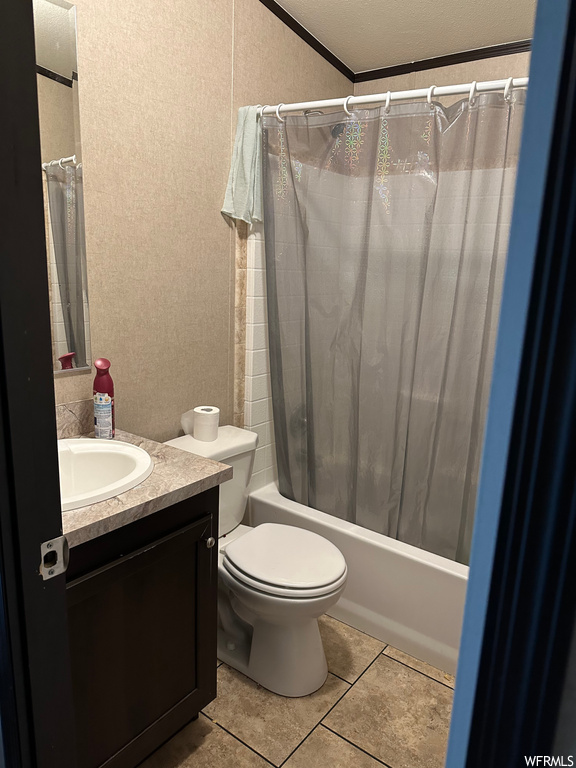 Full bathroom featuring light tile flooring, mirror, large vanity, and shower / bath combo