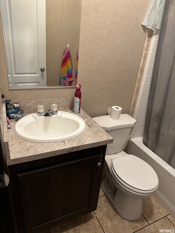 Full bathroom with backsplash, mirror, shower / bath combo, light tile floors, and oversized vanity