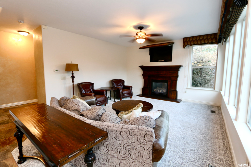 Living room featuring a fireplace and ceiling fan