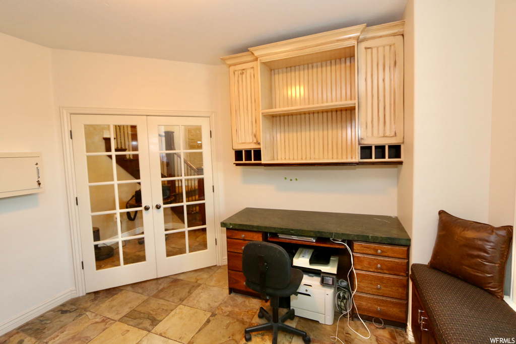 Office area featuring french doors and light tile floors