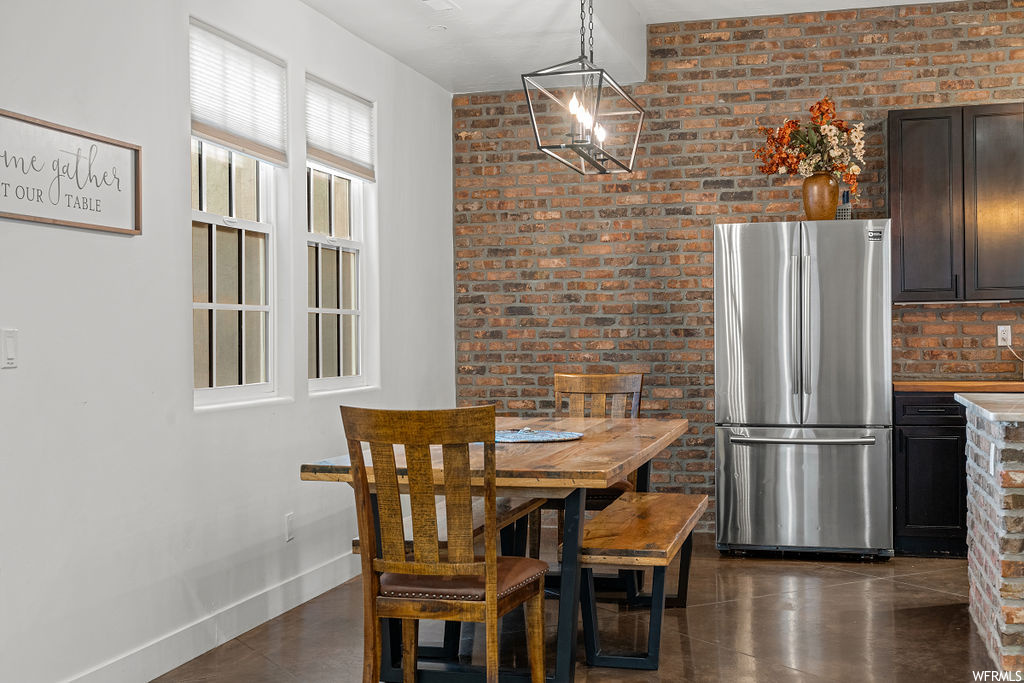 Dining room featuring brick wall