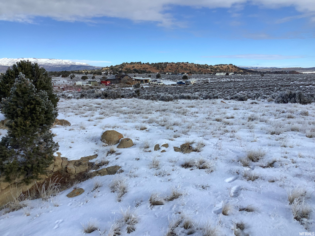 View of snow covered land with a water view