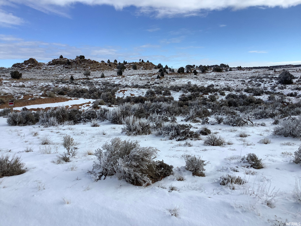 View of snow covered land featuring a water view