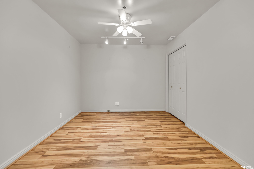 Spare room with light hardwood floors and ceiling fan