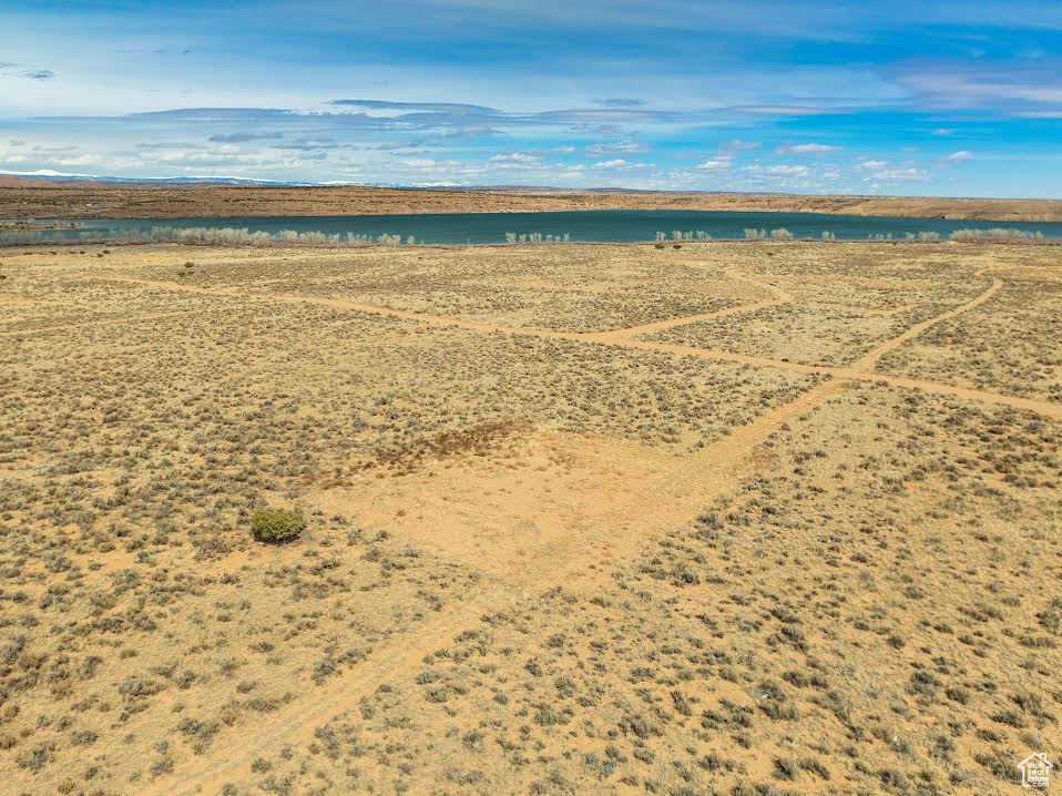 Birds eye view of property with a water view