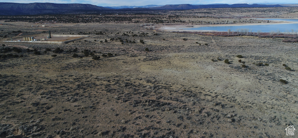 Drone / aerial view featuring a water and mountain view