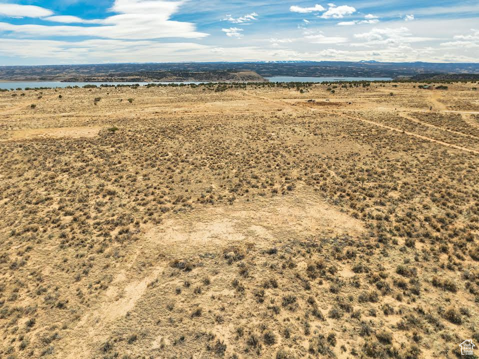 Birds eye view of property with a water view