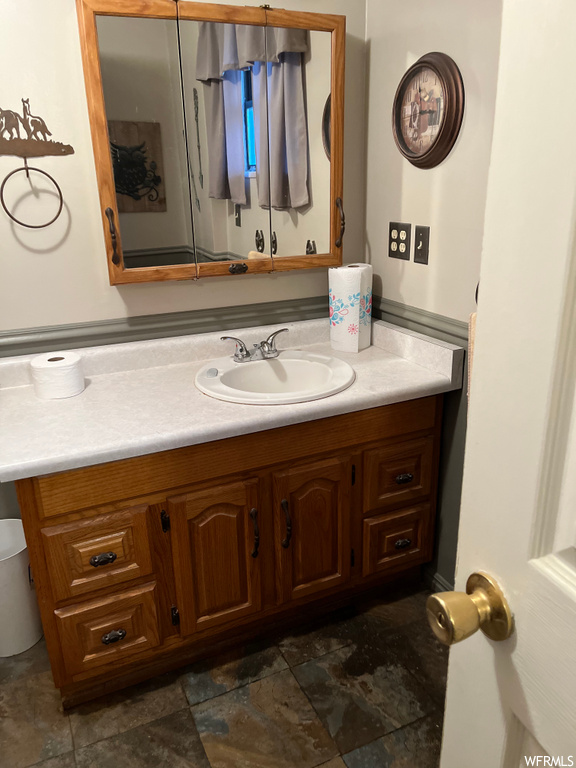 Bathroom with tile floors, large vanity, and mirror