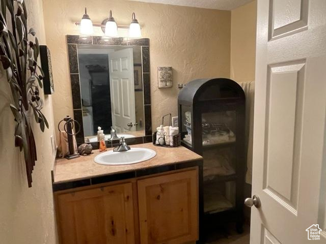 Bathroom with vanity with extensive cabinet space