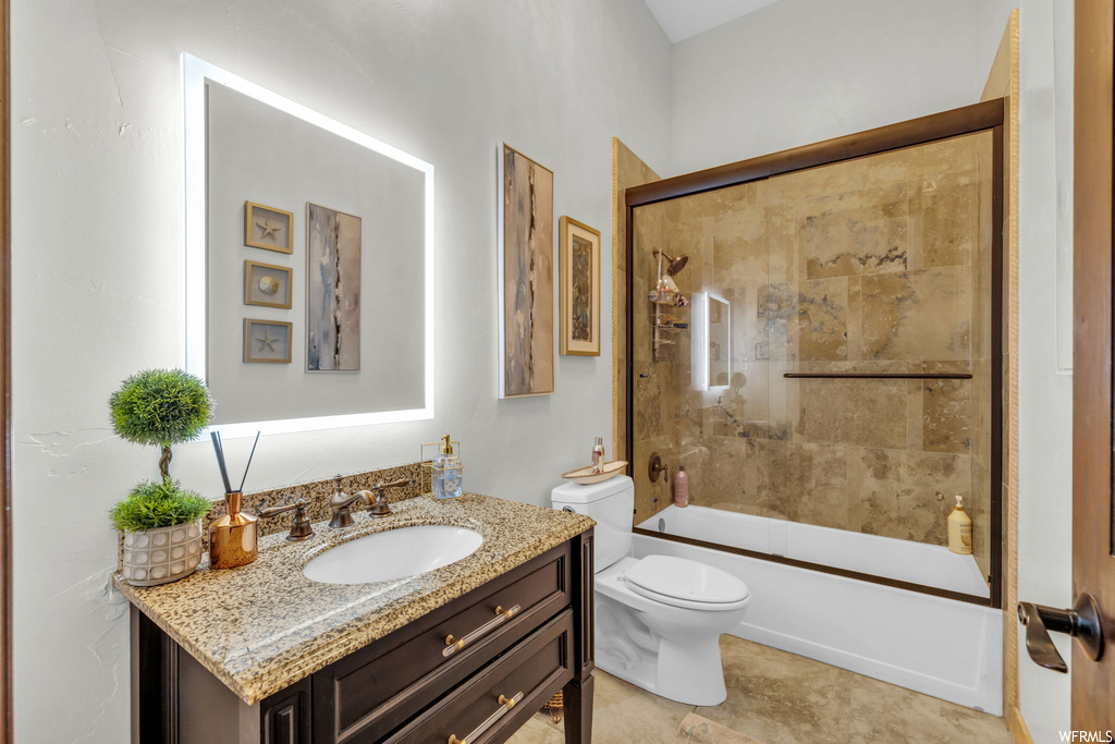 Full bathroom featuring oversized vanity, combined bath / shower with glass door, light tile flooring, and mirror