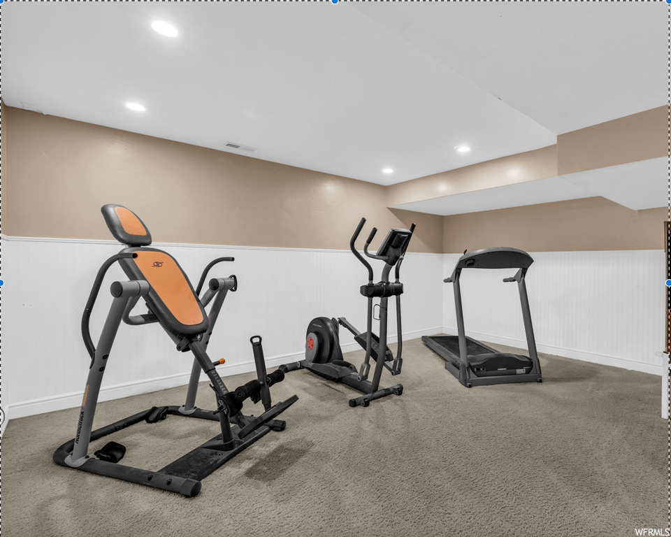 Workout room featuring light carpet