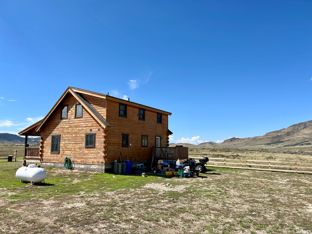 Back of house with central air condition unit and a mountain view