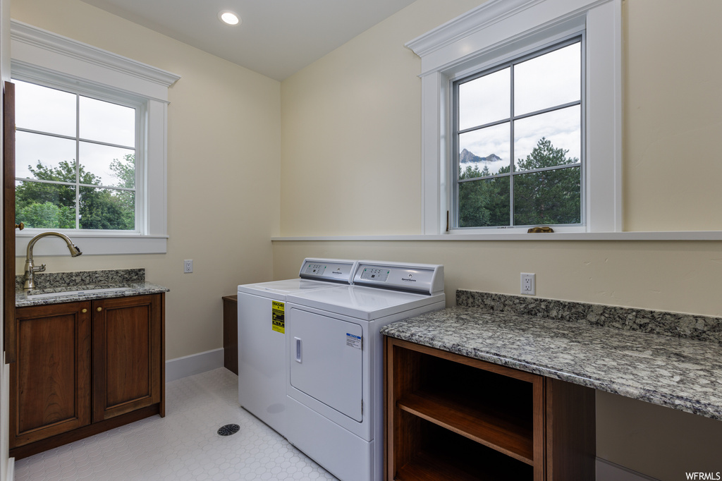 Laundry area featuring tile flooring and washer and clothes dryer
