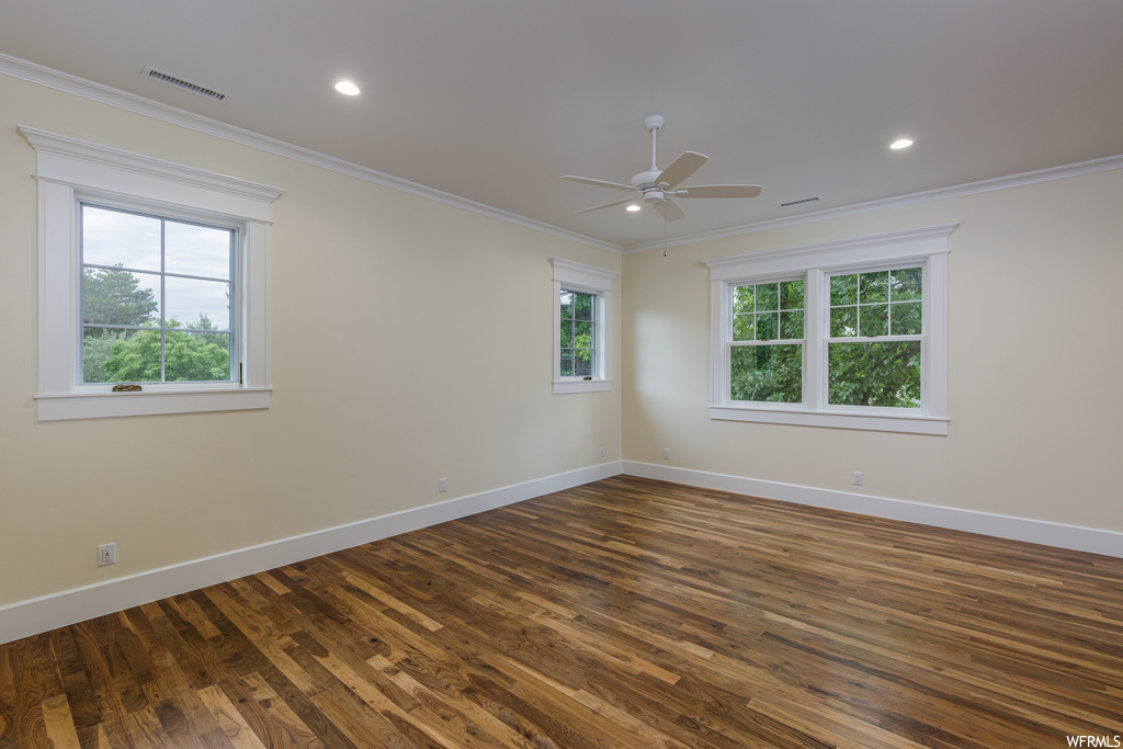 Unfurnished room with hardwood floors, ornamental molding, and ceiling fan