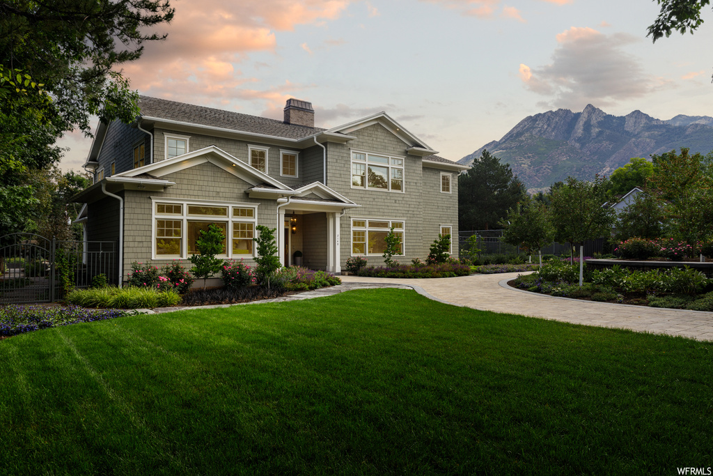 View of front facade featuring a lawn and a mountain view