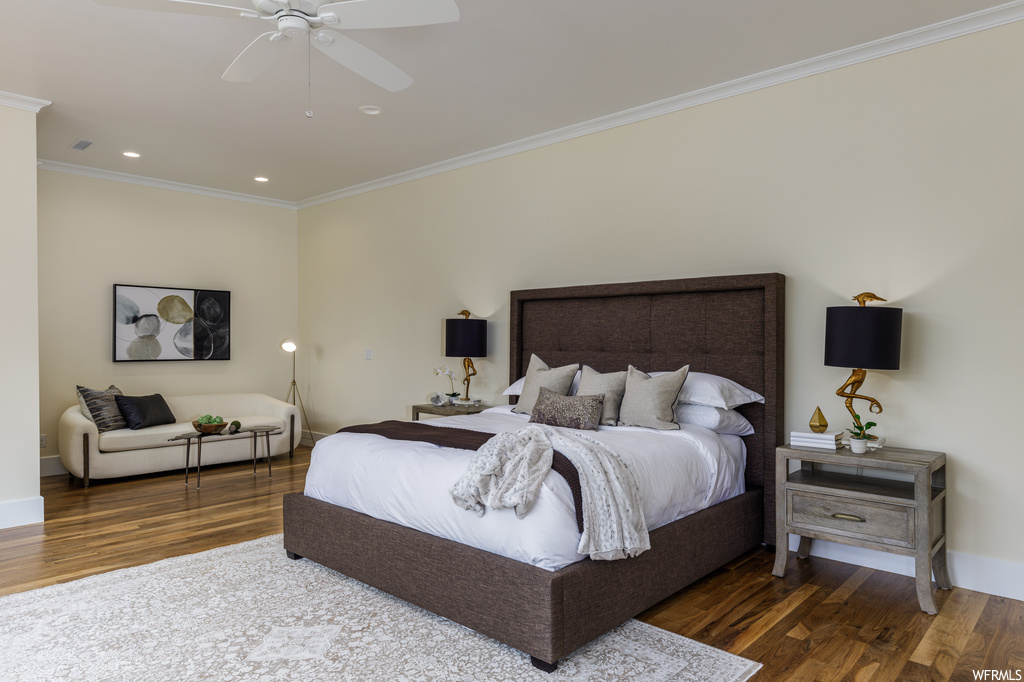 Bedroom with ceiling fan, hardwood flooring, and ornamental molding